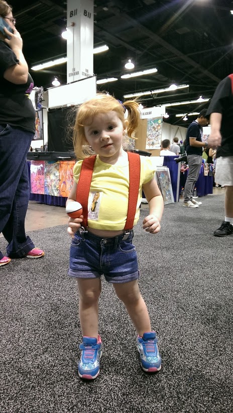 Little girl dressed as Misty, trying to catch them all.